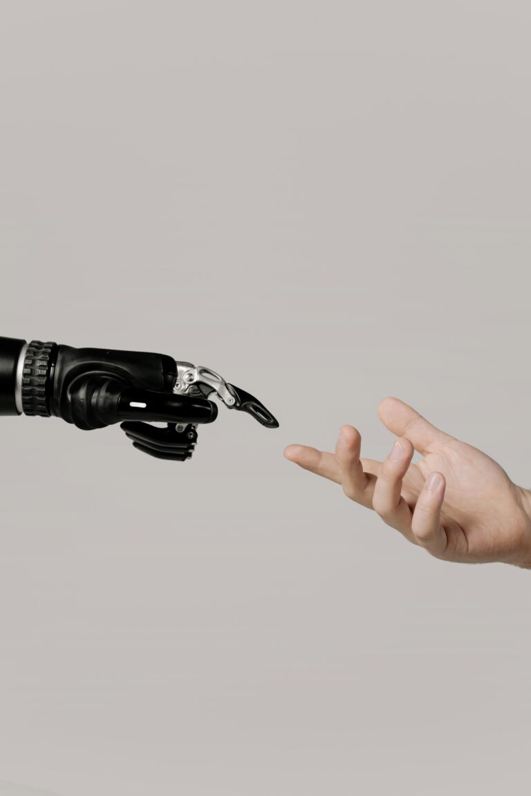 Photo of robot hand and human hand coming together