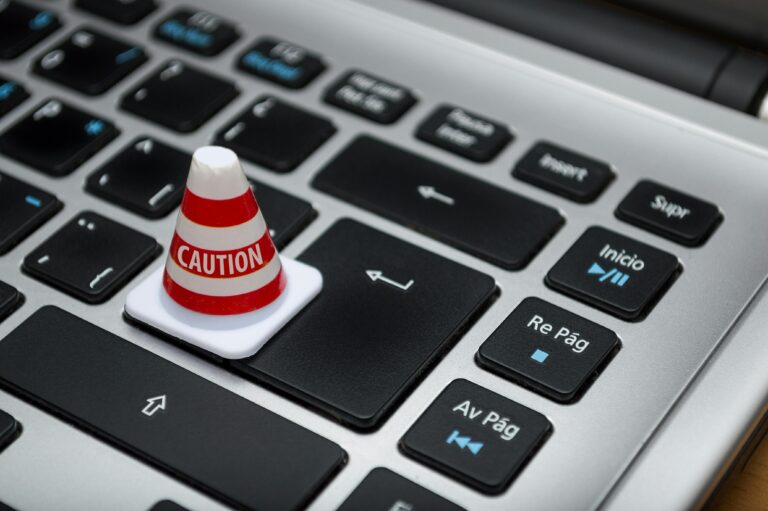 Photo of keyboard and caution sign