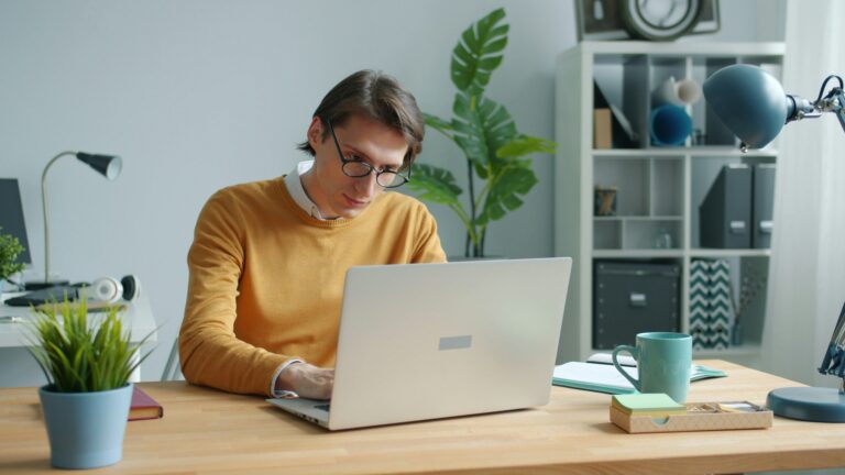 Photo of man at his laptop