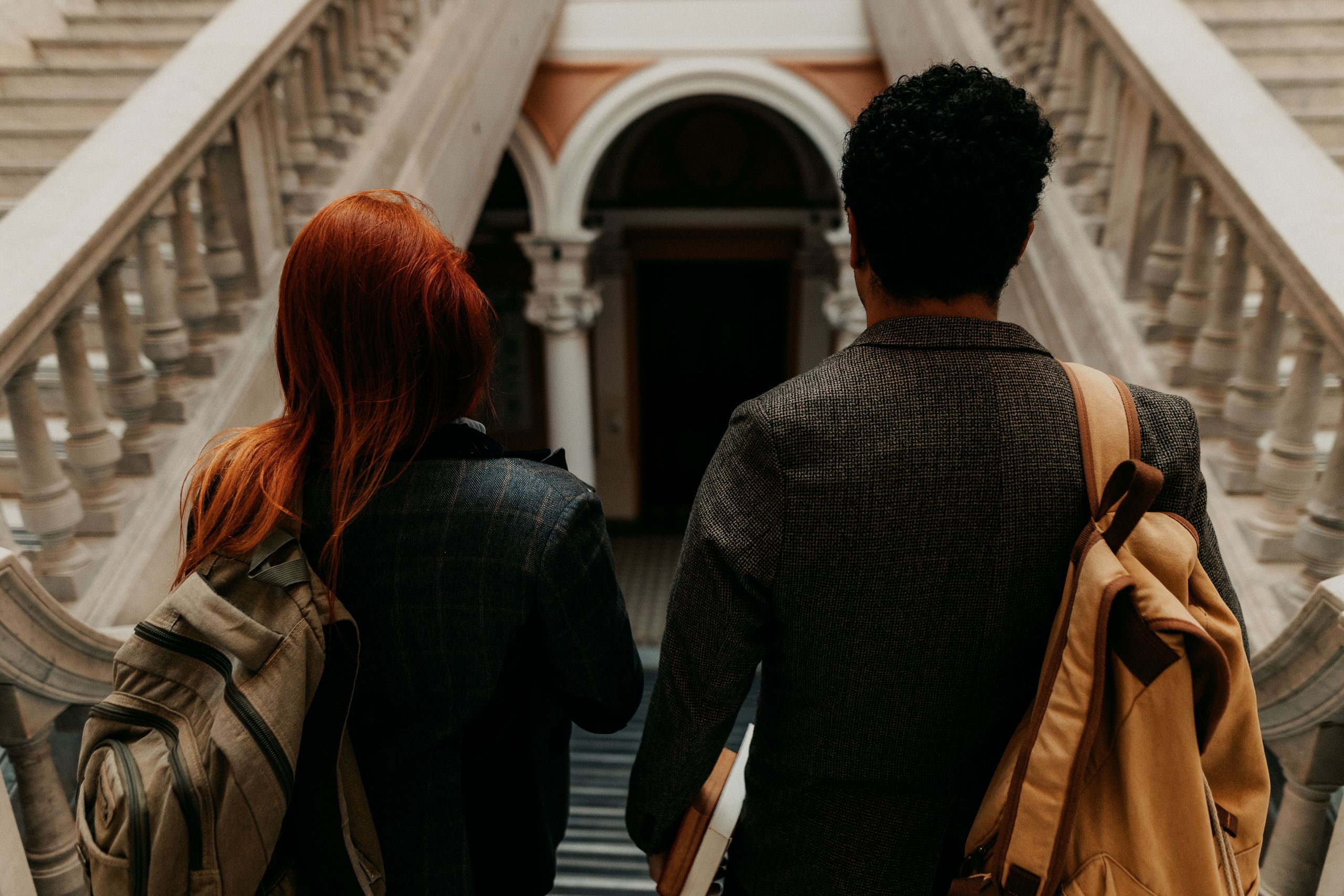 Photo of two university students walking down a grand staircase