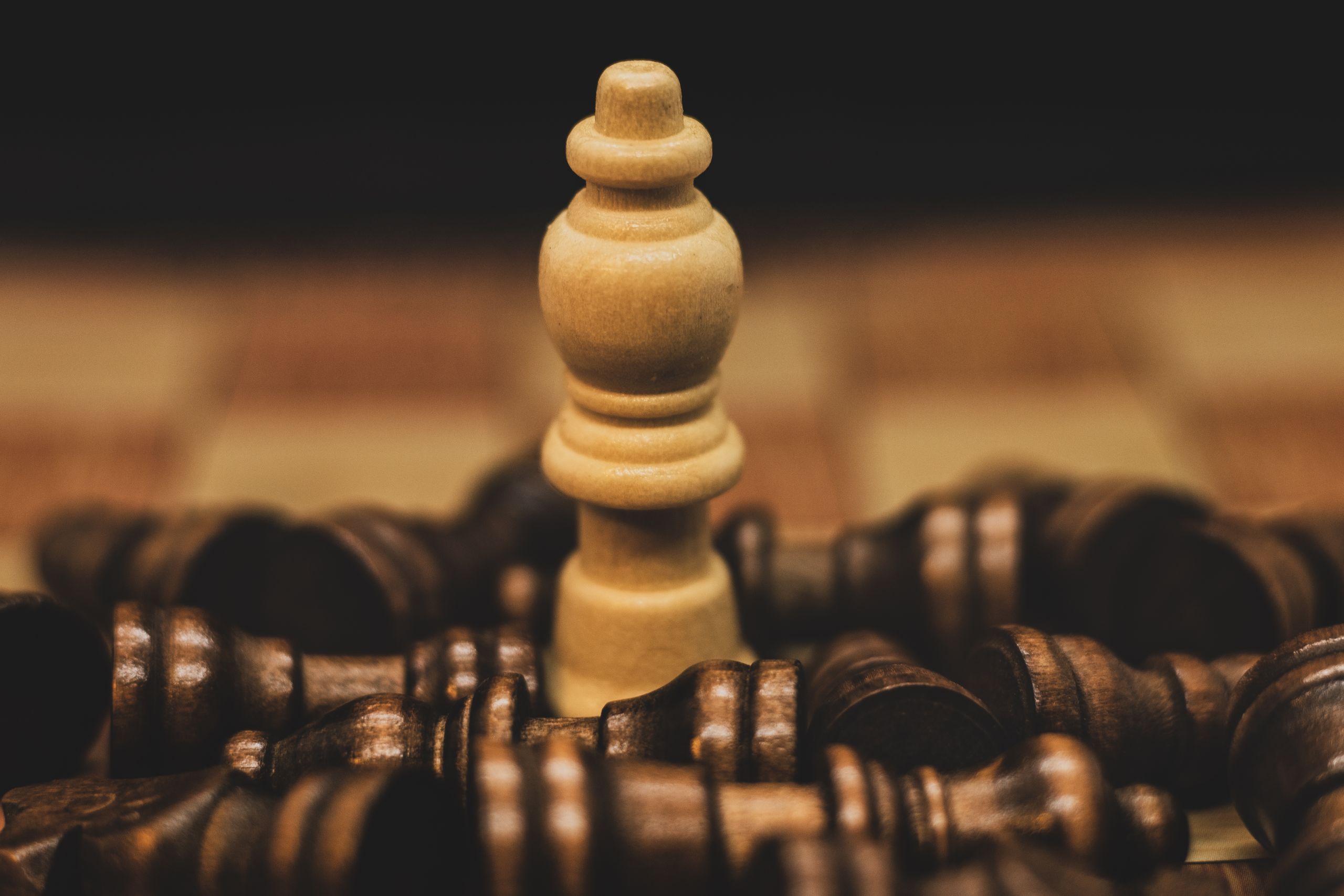 Photo of a chess piece standing over fallen pieces