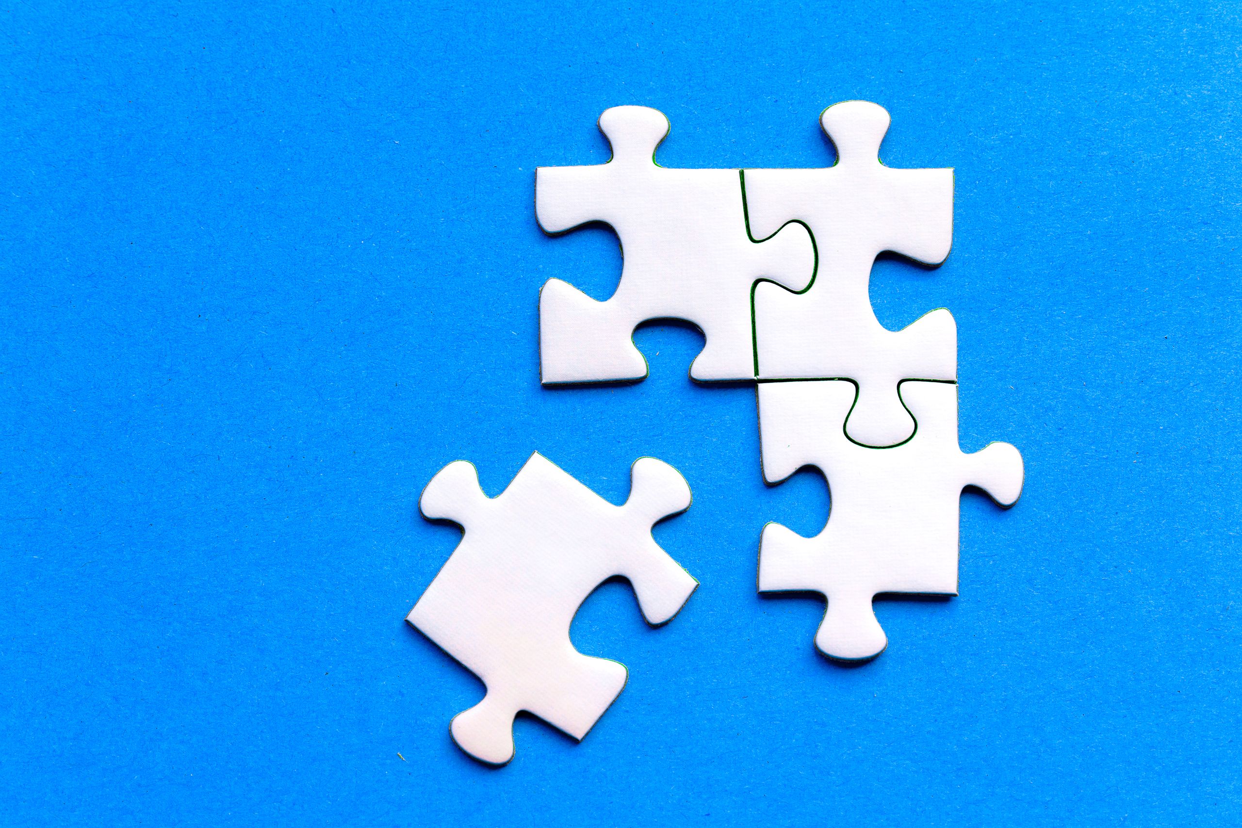 Photo of white puzzle pieces fitting together