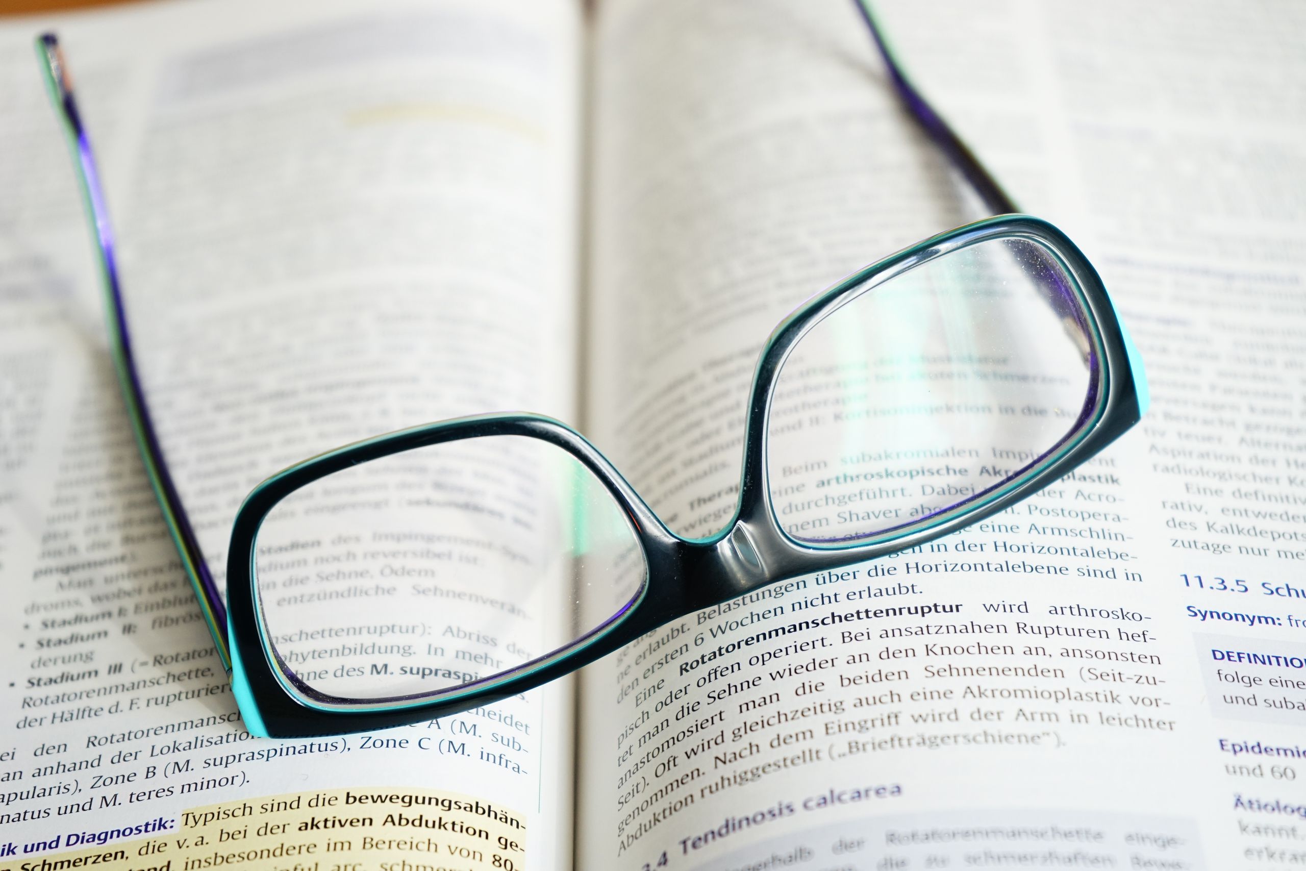 Photo of reading glasses on an open book