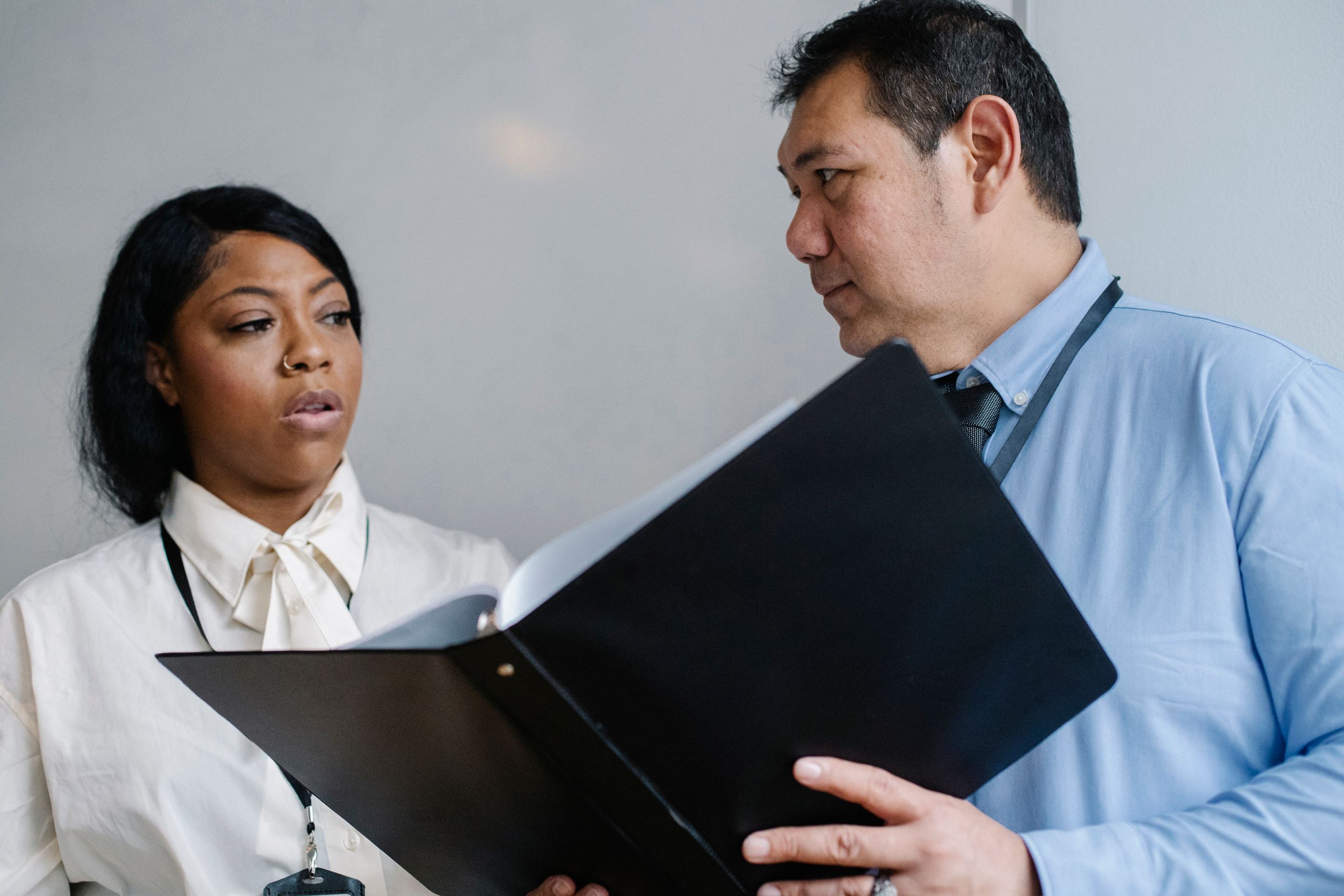 Photo of a manager showing documents to a colleague